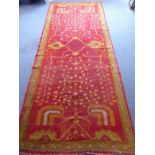 A large and interesting hand-knotted early/mid-20th century red-ground Persian Heriz-style carpet,