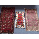 A hand-knotted Bokhara rug with elephant's foot pattern together with one other slightly smaller