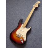A Squier Stratocaster (by Fender) six-string 20th anniversary issue electric guitar in sunburst,
