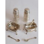 A pair of early-20th century silver-plated pepperettes, each engraved with monogram and with a lower