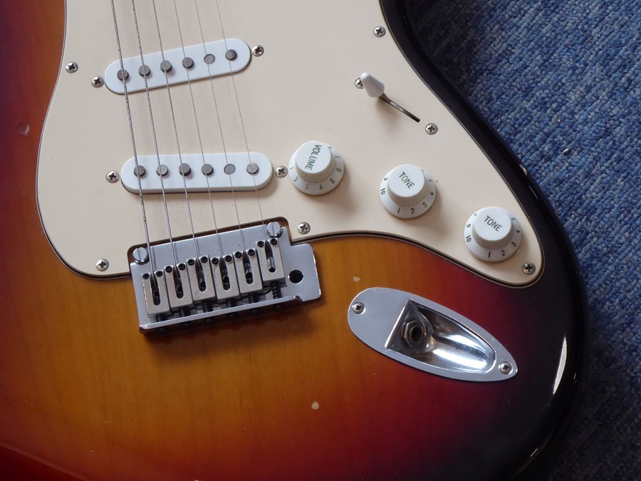 A Squier Stratocaster (by Fender) six-string 20th anniversary issue electric guitar in sunburst, - Image 3 of 5