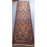 A Kazak/Caucasian hand-knotted runner, six stylised designs against a burnt umber ground and