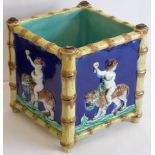 A 19th century Majolica jardiniere (possibly Minton) decorated in relief with each side displaying