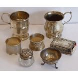 A small silver group to include two hallmarked Christening-style tankards, two napkin rings, a