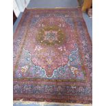 A large and heavy hand-knotted mid-20th century Persian Qum-style carpet, central flower-head design