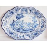 A 19th century Continental Faience platter of oval form with scallop edges, hand decorated with an