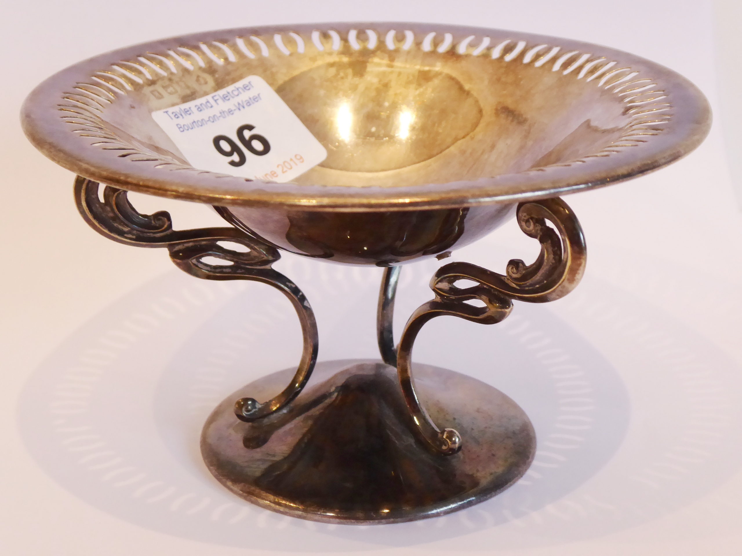 A small Arts and Crafts-style hallmarked silver dish; the bowl with pierced border above three