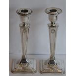 A pair of hallmarked silver table candlesticks in Classical style, detachable nozzles and on