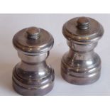A pair of white-metal salt/pepper grinders, each marked Tiffany & Co., sterling (6cm high)
