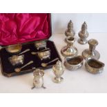 Various silver cruets and pepperettes etc., comprised of a cased set of four salts and spoons, a