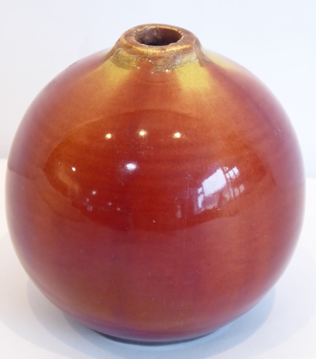 A 19th century Linthorpe pottery vase; of spherical form and with red and mustard trailing glazes,