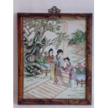 A faux bamboo-framed Chinese porcelain plaque, hand decorated in famille verte enamels depicting a