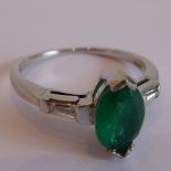 A fine emerald and diamond ring having marquise-shaped emerald with baguette diamond shouldersNo