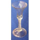 An 18th century style wine glass having a double spiral-twist stem and raised on circular folded