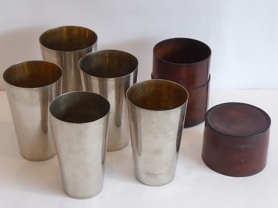 An early-20th century set of five silver-plated concentric beakers of tapering form within a hand-