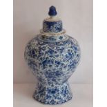 A 19th century Continental baluster shaped tin-glazed earthenware vase and cover hand-painted in