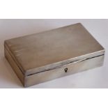 A rectangular white-metal lockable box with cedarwood interior and hinged lid, marked to the