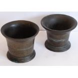 Two similar patinated bronze mortars each with flaring neck and horizontal bands (probably 18th