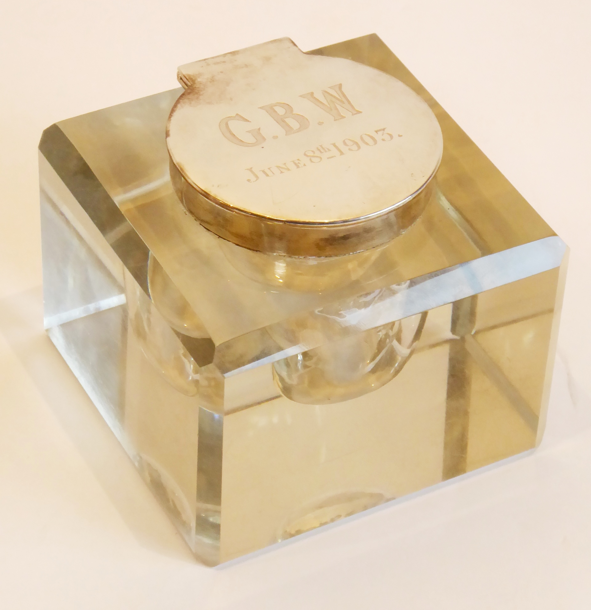 A large heavy cut-glass Edwardian inkwell of block shape with canted corners, the silver-mounted