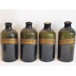 Four large 19th century green-glass chemist's bottles, each with labelled individually, 'LOT: