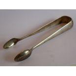 A pair of 19th century Russian silver sugar tongs engraved with cyrillic monogram (approx. 45.3g)