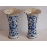 A pair of 18th/19th century Dutch Delftware vases of waisted form, each hand decorated with flower