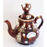 A large 19th century Barge ware pottery teapot decorated in relief with floral sprays, flower heads,