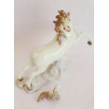 A late-19th/early-20th century hand-decorated porcelain model of a rearing white horse; probably