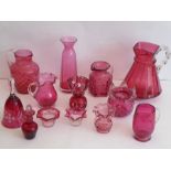 A selection of 19th century Cranberry and other later similar flash-cut glassware to include jugs,