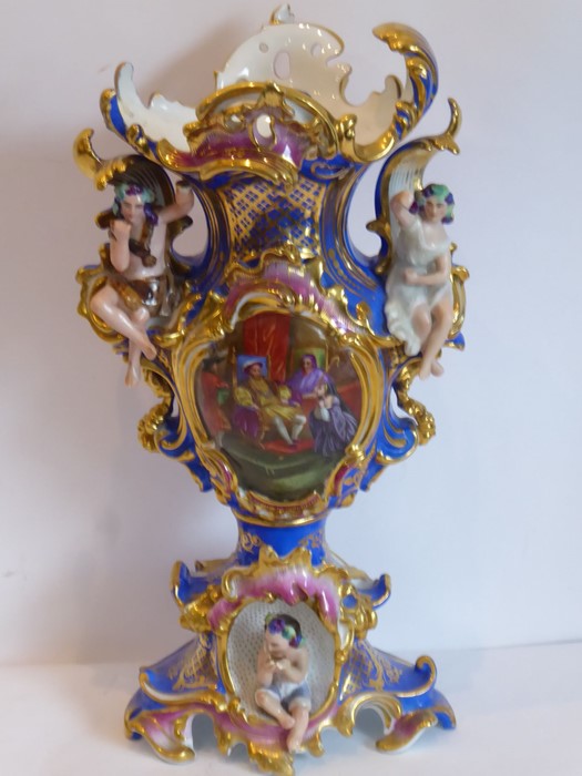 A large late 19th century Continental porcelain vase of elaborate rococo form; the central