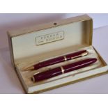 A cased mid-20th century Parker Demi Duofold fountain pen and pencil set, the fountain pen with 14-