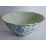 A Chinese porcelain bowl delicately hand-decorated in underglaze blue with lotus flowers, scrolls