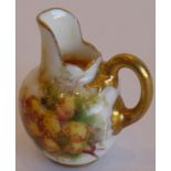 A rare Royal Worcester porcelain jug of tiny proportions, hand-painted with flowers and signed by