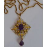 A 9-carat yellow-gold Arts and Crafts-style pendant centrally set with an oval amethyst above a