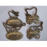 A pair of 19th century wine tickets of oval form 'Sherry' and 'Madeira', together with two further