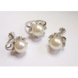 A very fine white-gold, pearl and diamond cluster ring together with matching earrings