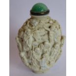 A good biscuit porcelain snuff bottle, probably circa 1800, the ovoid body crisply moulded in relief