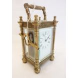 A late 19th century brass-cased carriage clock in 4-pillared case with blind fretwork friezes