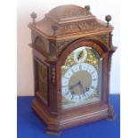 A fine late 19th century figured walnut cased eight-day bracket clock, the domed top carved with