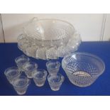 A large pressed clear-glass punch bowl together with 18 punch cups, plastic hooks, a plastic ladle