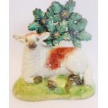 An early 19th century Staffordshire bocage model of a recumbent sheep in Walton style (9cm high x