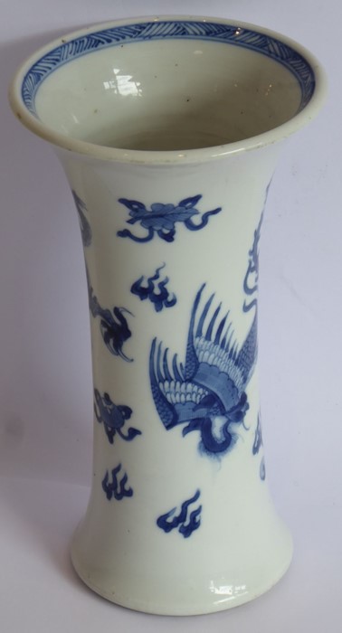 A blue and white trumpet vase in Kangxi style, 19th century, painted with a feng and dragon