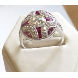 An 18-carat white-gold, ruby and diamond dress ring (1-carat centre stone)