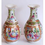 A pair of 19th century Chinese porcelain bottle vases; typically hand-decorated in famille-rose