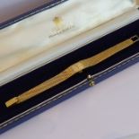 A ladies boxed 18-carat yellow-gold (marked 18) dress wristwatch having integral textured