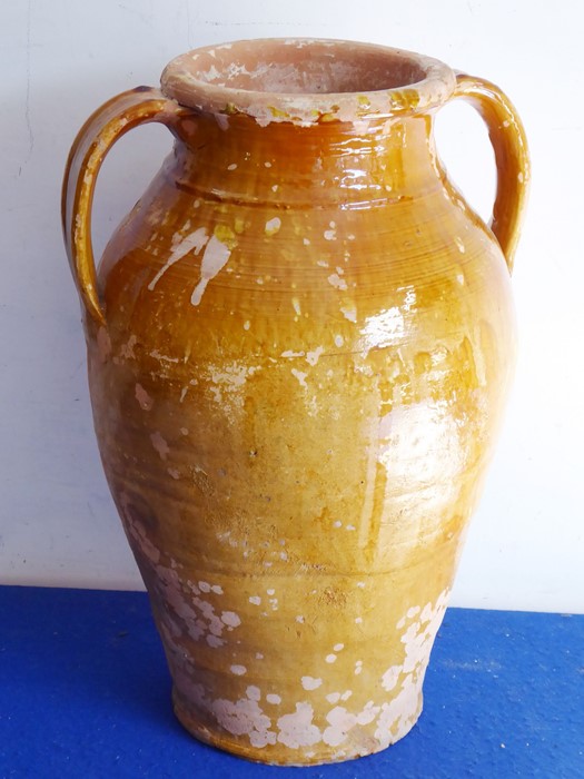 A Continental two-handled pottery olive jar with a mottled tan glaze, probably early 20th century (