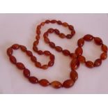 An early 20th century glass bead necklace from the Art Deco period and simulating amber, approx.