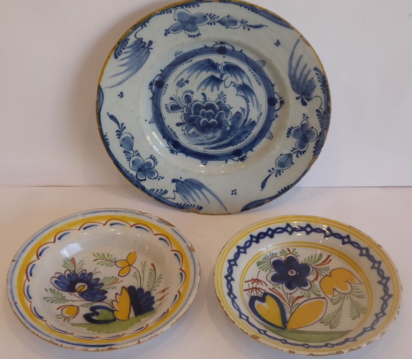 An 18th century Delftware dish typically decorated in underglaze blue with flowers and leaves