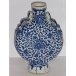 A 19th century Chinese porcelain moon flask hand-decorated in under-glaze blue with scrolling lotus,