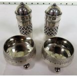 Pair of silver pepperettes together with a pair of salt cellars